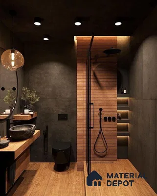 A bathroom with a large tub in the middle of it and wooden flooring next to a wooden table in front of a bathroom with black bench, brass accent lighting, brass finishes, dark painted door, antique rug. Foyer Design,